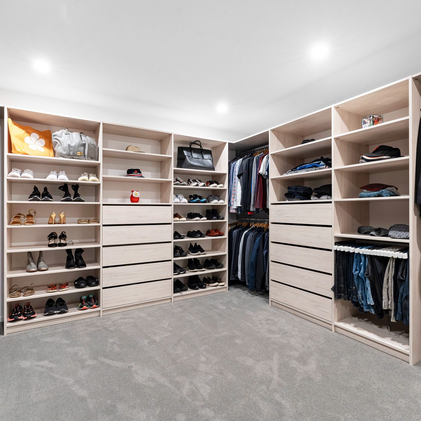 Flex walk-in wardrobe organiser in light woodgrain colour, wide shot of the whole large room