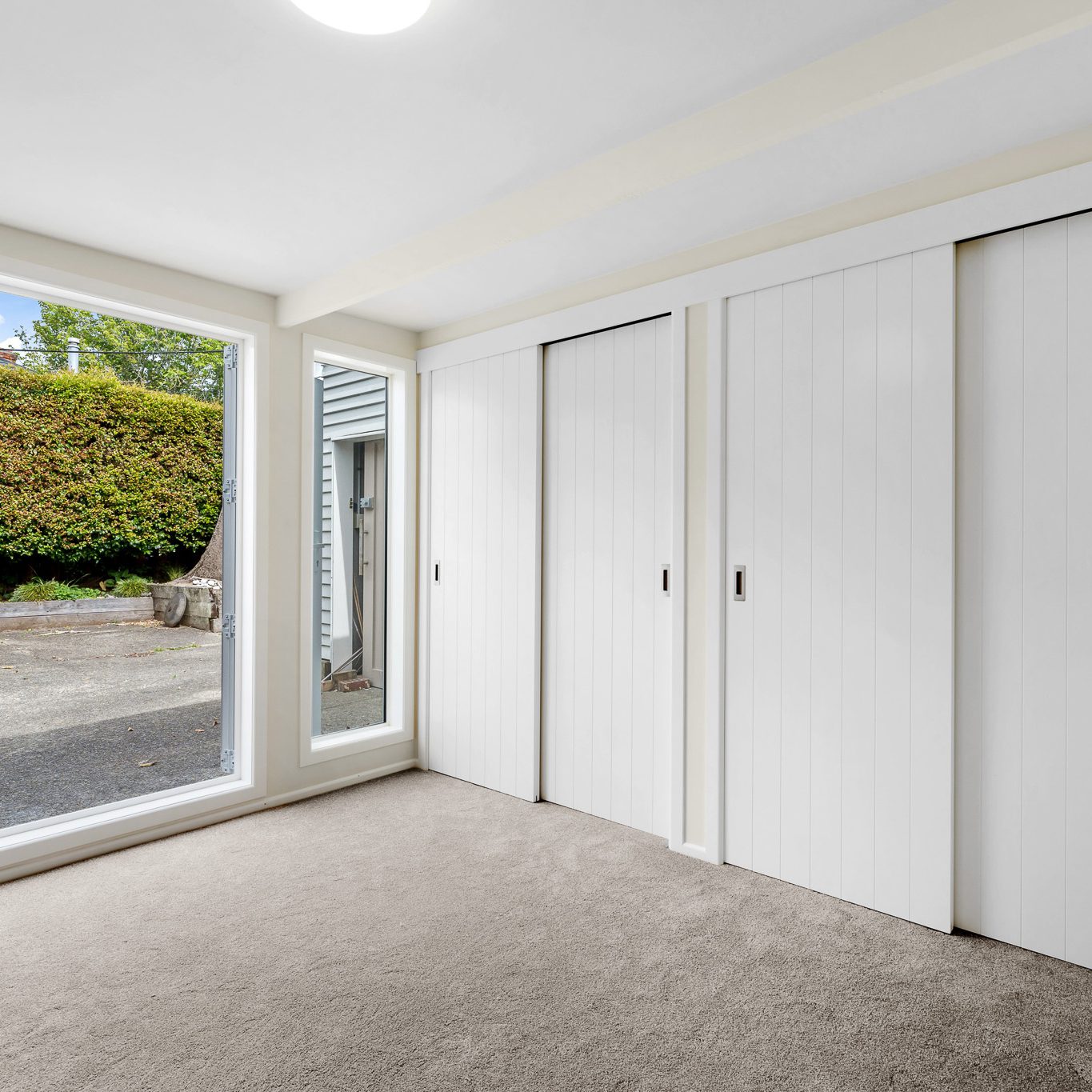 White Flush Panel sliding wardrobe doors with tongue and groove pattern